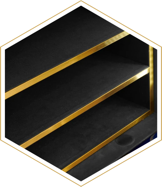 Soft-lined shelving with polished gold trim inside an Infinity safe